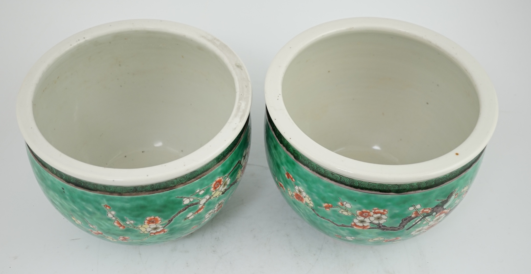 A pair of Chinese famille verte green ground jardinieres, Kangxi marks, but late 19th century